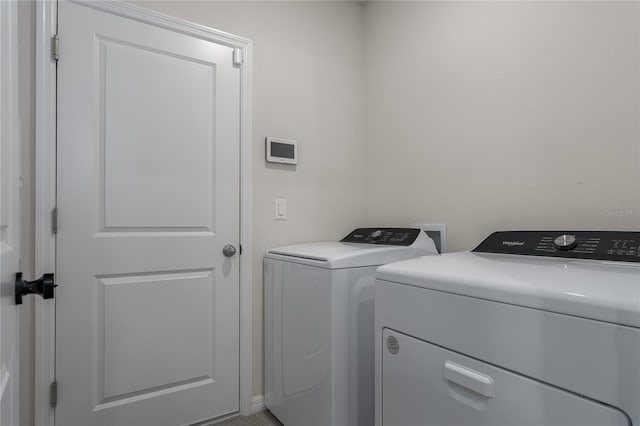 clothes washing area featuring independent washer and dryer