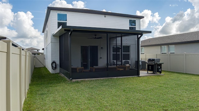 back of house featuring a sunroom and a yard