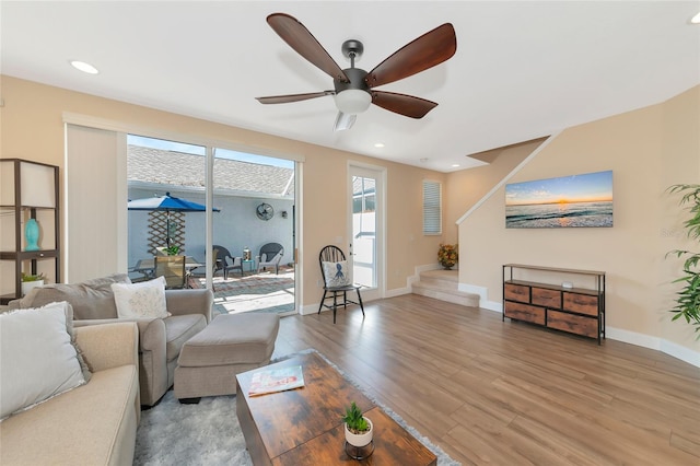 living room with ceiling fan and wood-type flooring