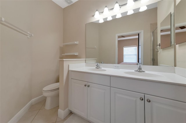 bathroom featuring walk in shower, tile patterned flooring, vanity, and toilet