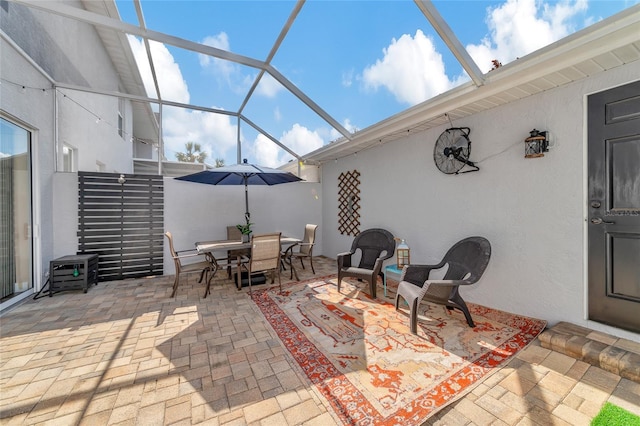 view of patio with glass enclosure