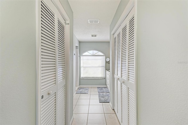 4135 Dover Dr E, Bradenton, FL 34203 - hall featuring a textured ceiling and light tile patterned floors