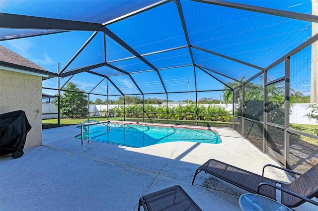 view of swimming pool featuring a lanai and a patio