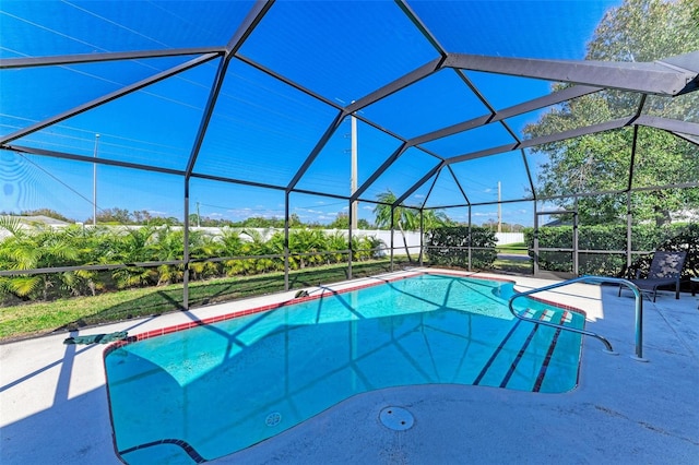 view of pool featuring glass enclosure and a patio