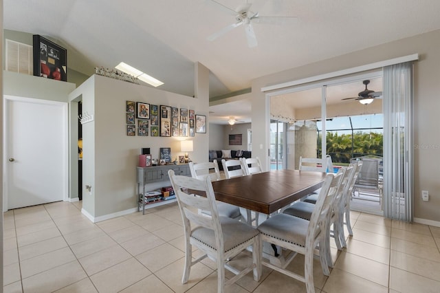 tiled dining space featuring ceiling fan and lofted ceiling