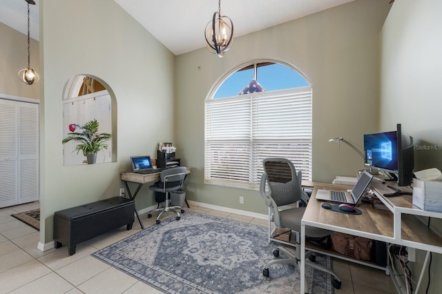 tiled home office with high vaulted ceiling and a chandelier