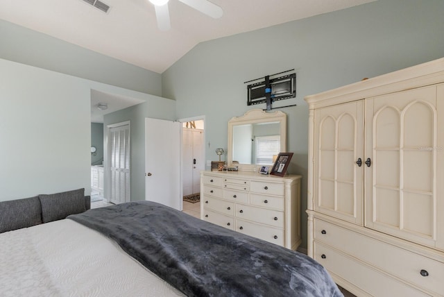 bedroom featuring ceiling fan, vaulted ceiling, and ensuite bathroom