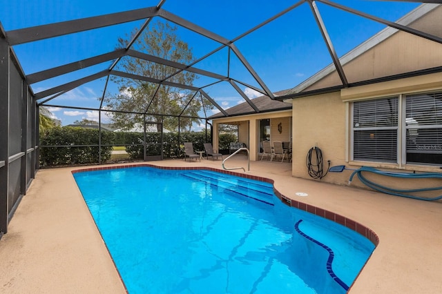 view of swimming pool with a lanai and a patio