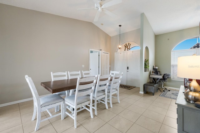 dining area featuring vaulted ceiling, ceiling fan, and light tile patterned floors