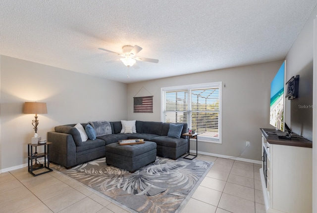 4135 Dover Dr E, Bradenton, FL 34203 - living room with a ceiling fan, light tile patterned flooring, a textured ceiling, and baseboards