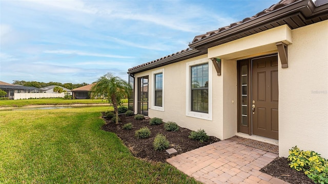 5431 Taliaferro Ct, Palmetto, FL 34221 - property entrance featuring stucco siding, a yard, and a water view