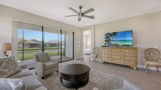 living room featuring ceiling fan and tile patterned floors