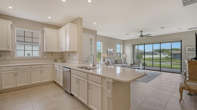 kitchen featuring white cabinets, light tile patterned floors, sink, and kitchen peninsula