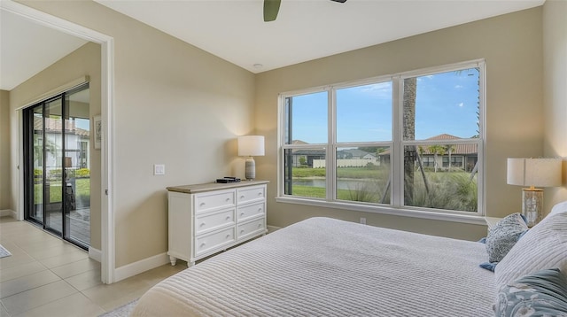 tiled bedroom featuring ceiling fan, multiple windows, lofted ceiling, and access to outside