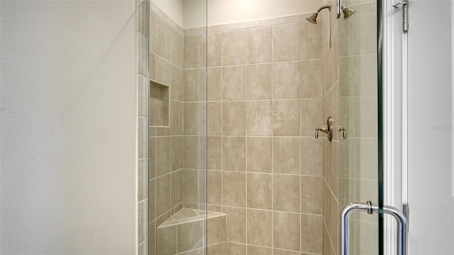 bathroom with a shower with shower door