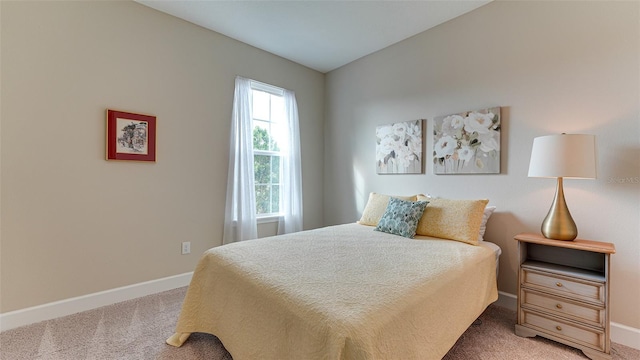 bedroom featuring carpet and vaulted ceiling