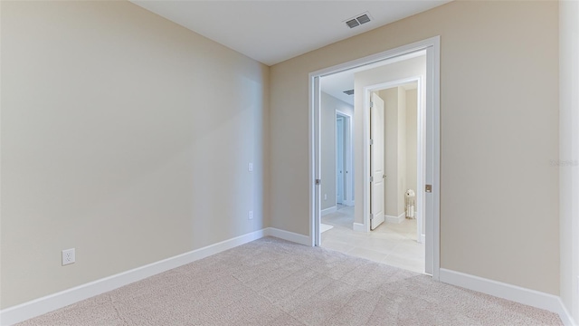 spare room with light colored carpet