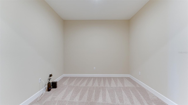 empty room featuring light carpet