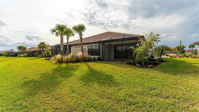 5431 Taliaferro Ct, Palmetto, FL 34221 - rear view of property with a yard, a lanai, stucco siding, and a tile roof