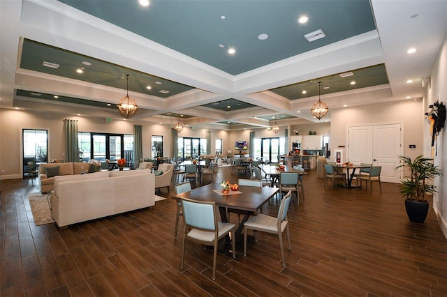 dining space featuring dark hardwood / wood-style flooring, beam ceiling, coffered ceiling, and an inviting chandelier