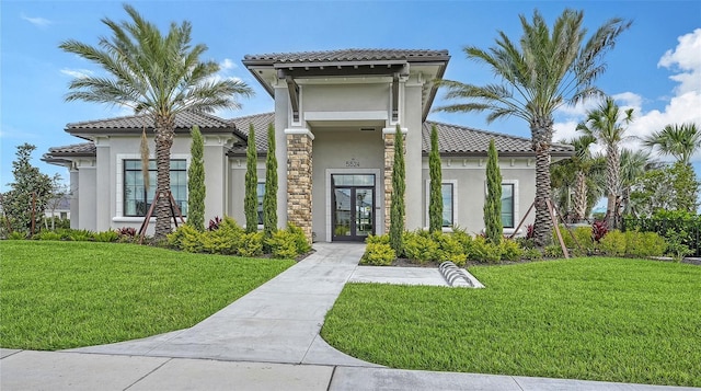 5431 Taliaferro Ct, Palmetto, FL 34221 - view of front of property featuring stucco siding, french doors, a tile roof, and a front lawn