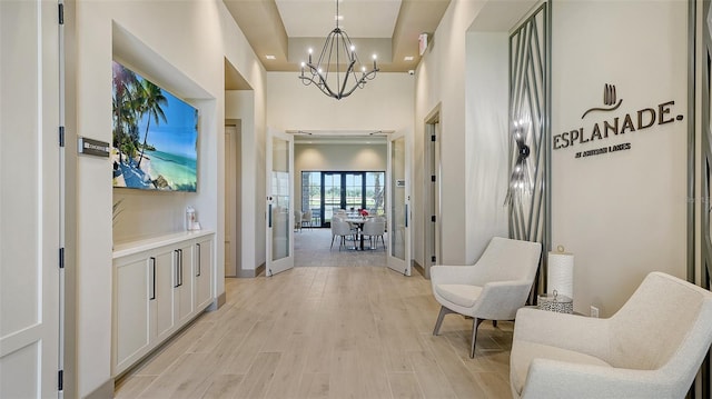 5431 Taliaferro Ct, Palmetto, FL 34221 - hallway with a chandelier, light wood finished floors, baseboards, a towering ceiling, and recessed lighting