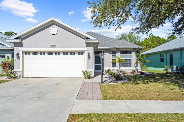 ranch-style house featuring a garage and a front lawn