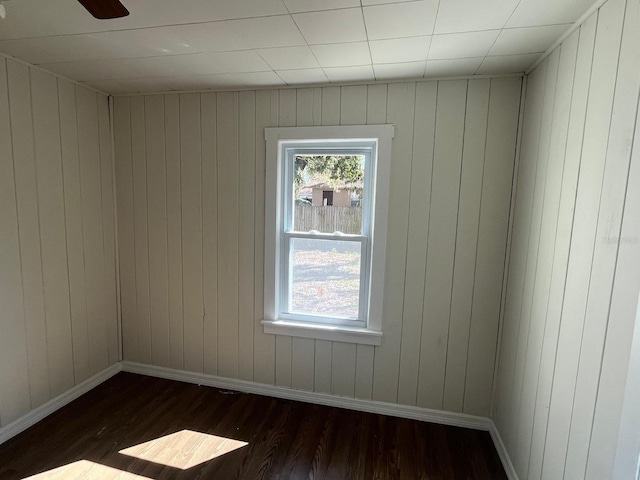 spare room with dark wood finished floors and baseboards