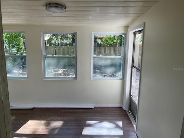 spare room with a healthy amount of sunlight, wood ceiling, baseboards, and wood finished floors