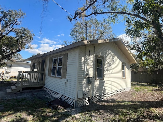 view of property exterior with crawl space and a wooden deck