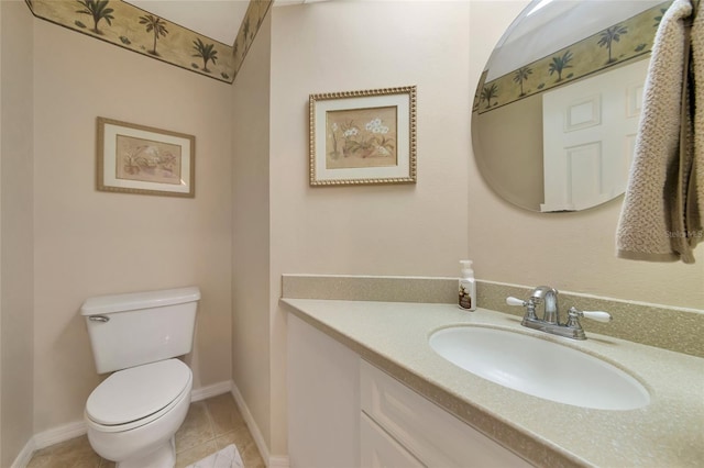 half bath featuring vanity, tile patterned floors, toilet, and baseboards