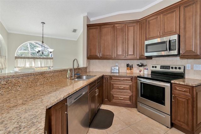 kitchen featuring sink, an inviting chandelier, light stone counters, light tile patterned floors, and appliances with stainless steel finishes