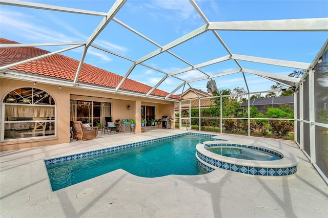 view of swimming pool with a lanai, a patio area, an in ground hot tub, and area for grilling