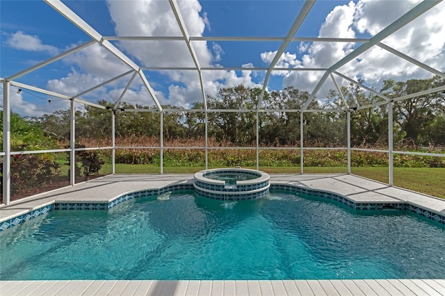 view of pool featuring a lanai, a patio area, and a pool with connected hot tub