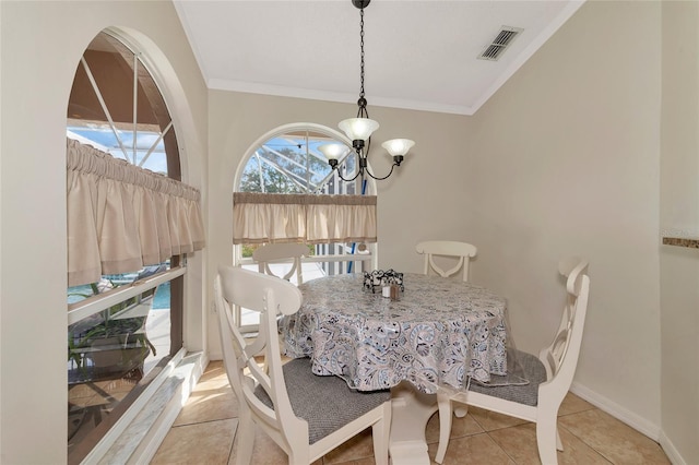 tiled dining room featuring crown molding and a chandelier