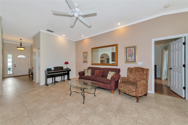 living area featuring light tile patterned floors, visible vents, baseboards, and ornamental molding