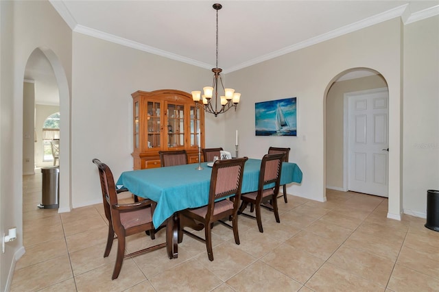 dining room featuring crown molding, baseboards, light tile patterned floors, an inviting chandelier, and arched walkways