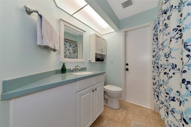 bathroom with visible vents, toilet, a shower with shower curtain, tile patterned flooring, and vanity