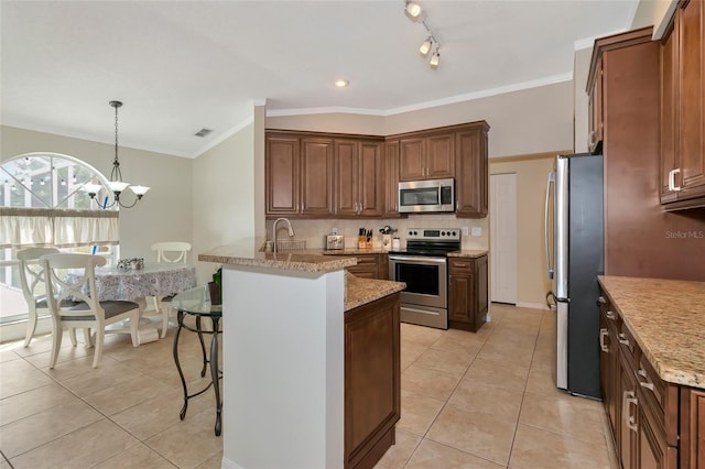 kitchen featuring backsplash, a breakfast bar area, light tile patterned floors, appliances with stainless steel finishes, and a peninsula