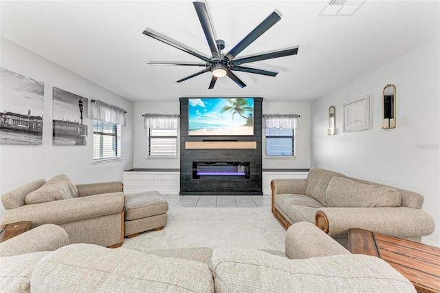 living room featuring a fireplace, a wealth of natural light, and ceiling fan