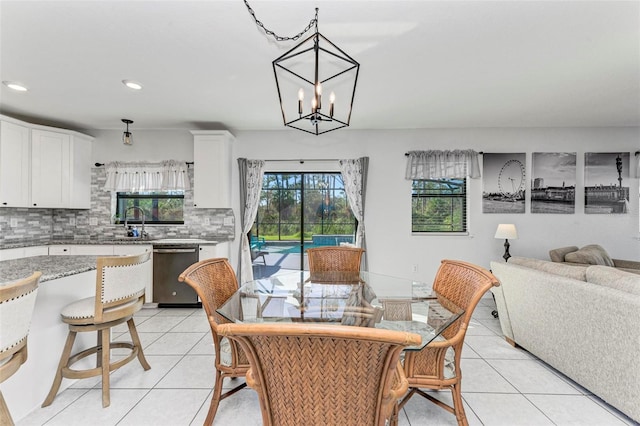 tiled dining space with a notable chandelier