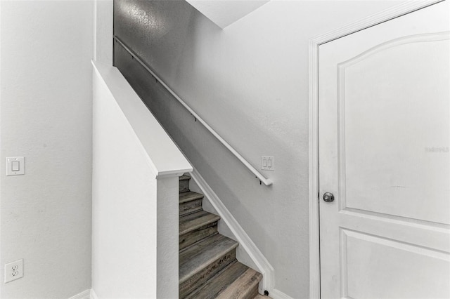 staircase with hardwood / wood-style flooring