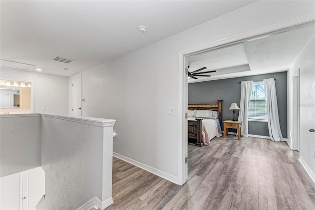 corridor with hardwood / wood-style floors