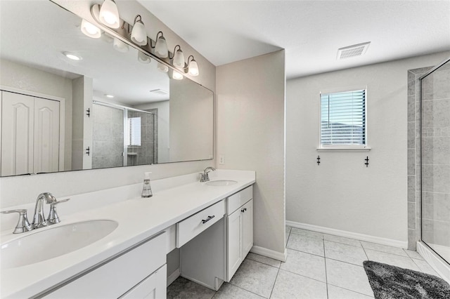 bathroom featuring vanity, a shower with door, and tile patterned floors