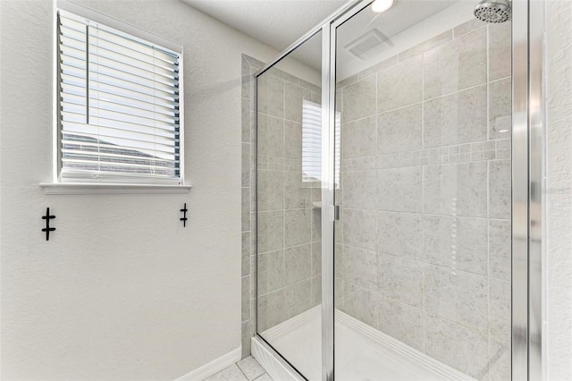 bathroom featuring a shower with door