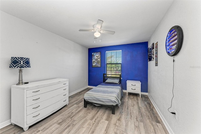 bedroom featuring light hardwood / wood-style flooring and ceiling fan