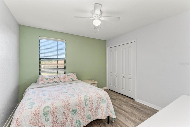 bedroom with ceiling fan, a closet, and light wood-type flooring