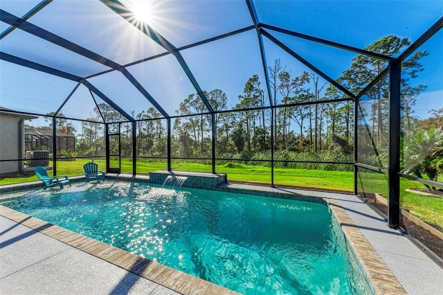 view of swimming pool with a patio, a lawn, a lanai, and pool water feature