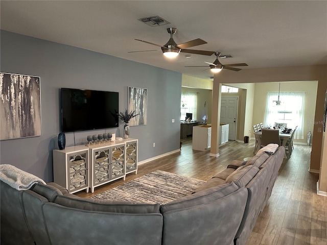 living room featuring hardwood / wood-style floors and ceiling fan