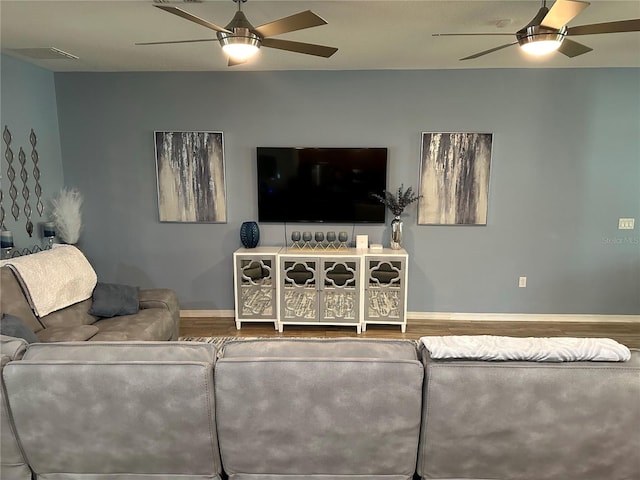 living room with wood-type flooring and ceiling fan